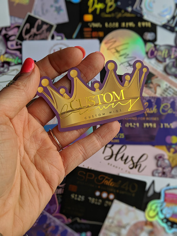 Crown shaped business cards with our shiny gold foil added to the text and outline of the crown. These die cut business cards were designed and printed by ShaynaMade in Goldsboro NC. The royal color of purple is outlining the entire logo.