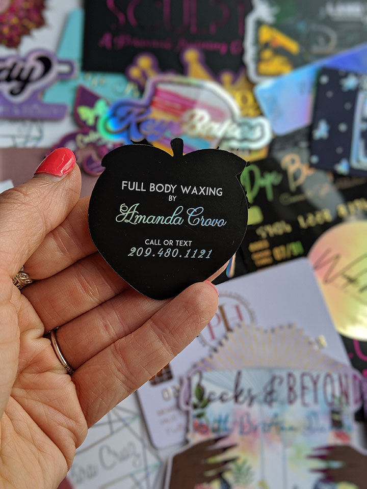This is showing the backside of the peach custom shaped business cards with holographic foil. These were designed and printed by the ShaynaMade team that is based in North Carolina.